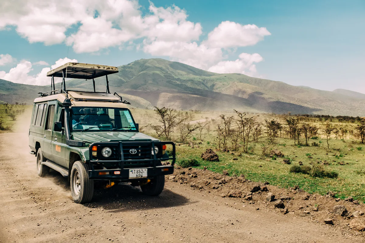 A safari vehicle on a savanna track
